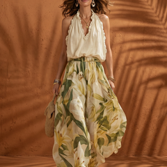 Floral wide-leg set featuring a halter neck blouse from THE WHITMORE FAMILY's Solange collection, displayed on a model.