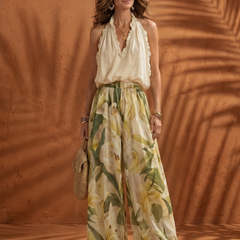 Floral wide-leg set featuring a halter neck blouse from THE WHITMORE FAMILY's Solange collection, displayed on a model.