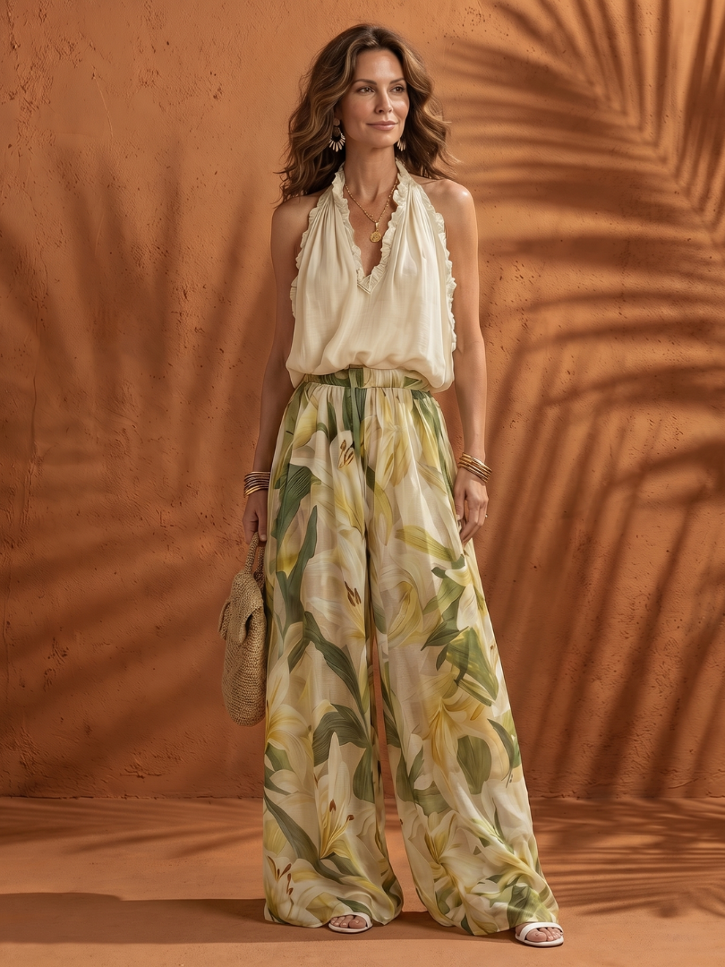 Floral wide-leg set featuring a halter neck blouse from THE WHITMORE FAMILY's Solange collection, displayed on a model.