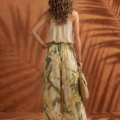 Solange floral halter neck blouse and wide-leg pants set by THE WHITMORE FAMILY, featuring a vibrant floral pattern and flowing fabric.