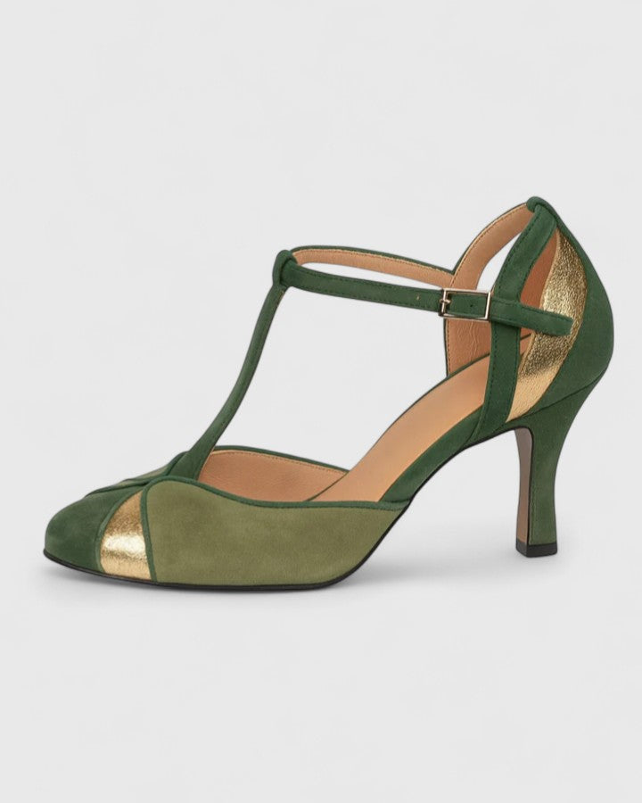 Green Coralise sophisticated heels by THE WHITMORE FAMILY featuring a sleek design and pointed toe on a stylish model.