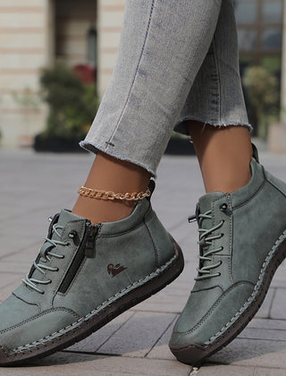 Green Émy ergonomic support sneakers by THE WHITMORE FAMILY with cushioned soles and breathable mesh upper.