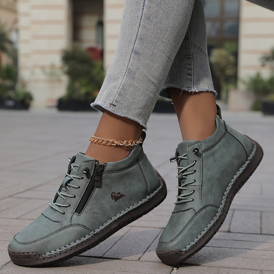 Green Émy ergonomic support sneakers by THE WHITMORE FAMILY with cushioned soles and breathable mesh upper.