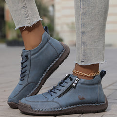 Green Émy™ ergonomic support sneakers by THE WHITMORE FAMILY, featuring cushioned soles and breathable material for comfortable wear.