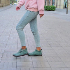 Green Émy™ ergonomic support sneakers by THE WHITMORE FAMILY featuring cushioned soles and breathable mesh upper.
