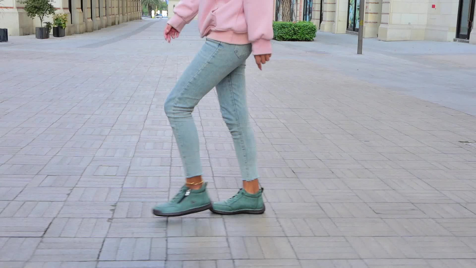Green Émy™ ergonomic support sneakers by THE WHITMORE FAMILY featuring cushioned soles and breathable mesh upper.