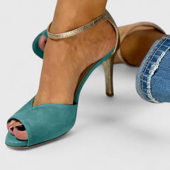 Green Nolavie elegant heels by THE WHITMORE FAMILY, showcasing stylish pointed toes and sleek design.