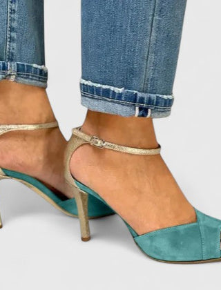 Green Nolavie elegant heels by THE WHITMORE FAMILY featuring sleek design and pointed toes, perfect for formal occasions.