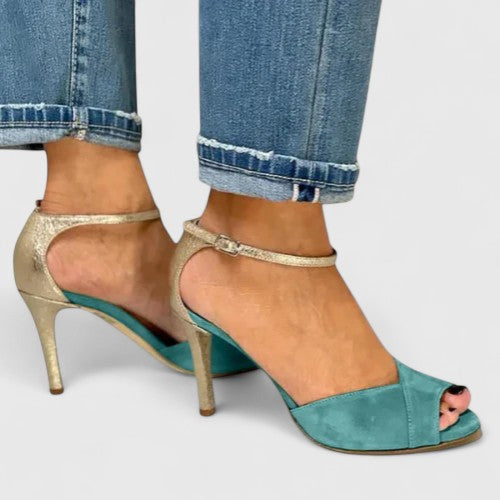 Green Nolavie elegant heels by THE WHITMORE FAMILY featuring sleek design and pointed toes, perfect for formal occasions.