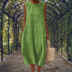 Green Aikaterini sleeveless dress by THE WHITMORE FAMILY with elegant design and practical pockets.