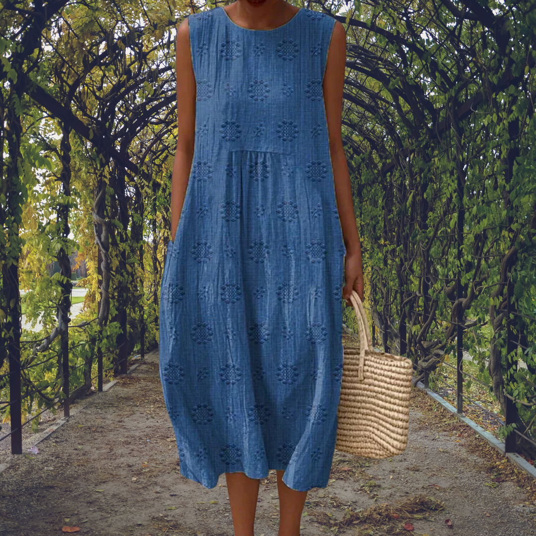 Elegant sleeveless Aikaterini dress by THE WHITMORE FAMILY in green with pockets, shown on a model.