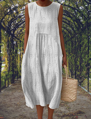 Green Aikaterini elegant sleeveless dress with pockets by THE WHITMORE FAMILY, shown on a model with a fitted silhouette.