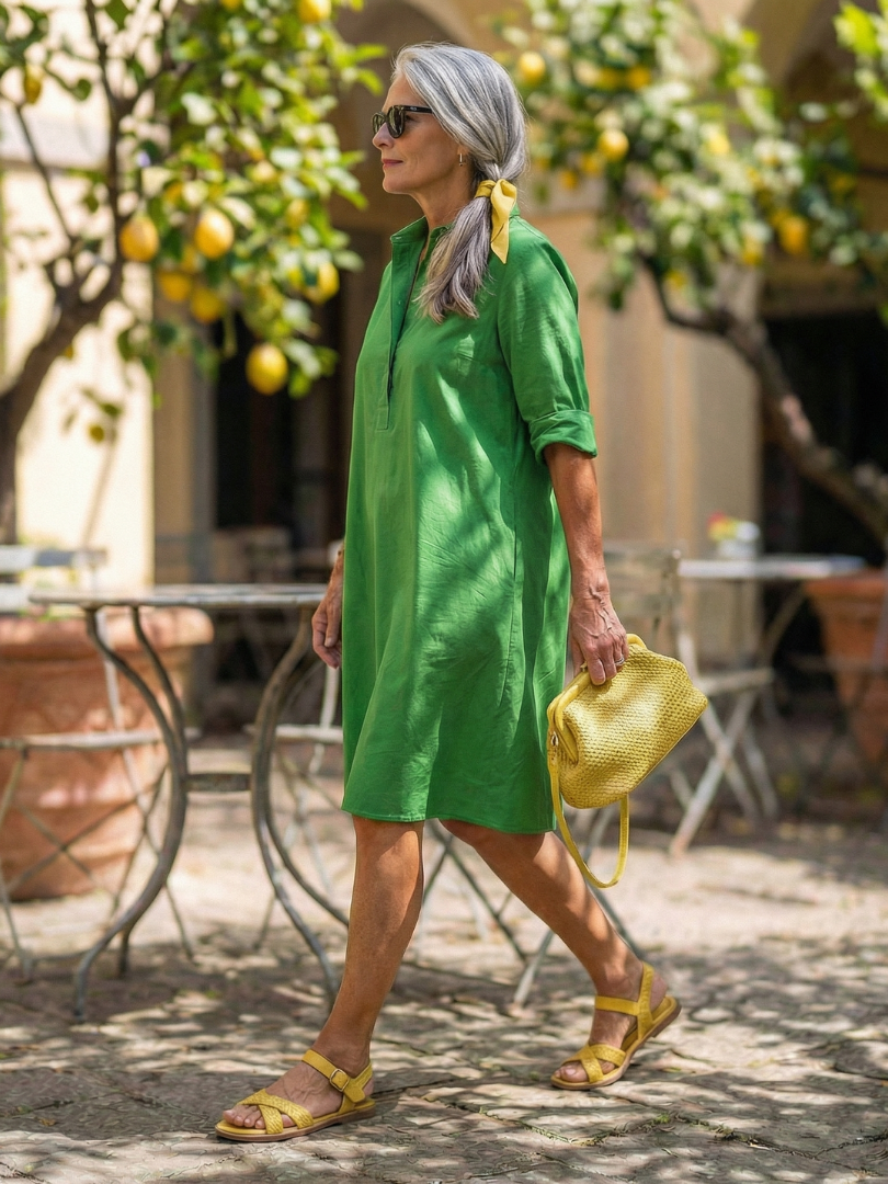 Green Giselle Morning Garden Dress by THE WHITMORE FAMILY, flowing fabric with floral pattern and elegant design.