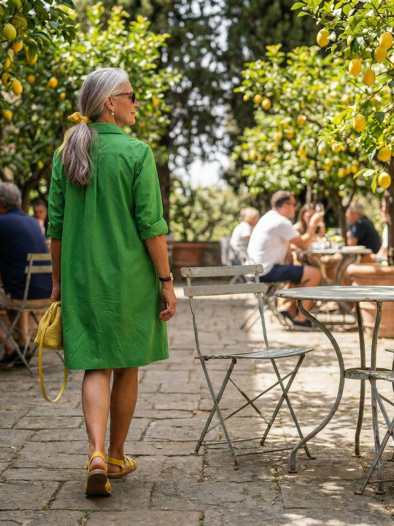 Green Giselle Morning Garden Dress by THE WHITMORE FAMILY, featuring floral patterns and flowing fabric.