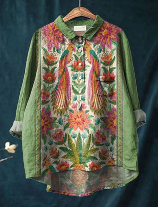 Nina Tropical Peacock Shirt by THE WHITMORE FAMILY, green fabric with vibrant peacock feather pattern, short-sleeve casual top.