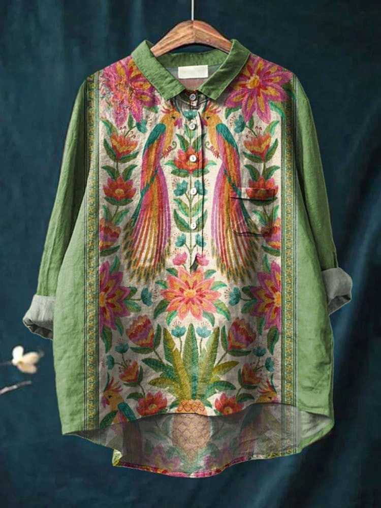 Nina Tropical Peacock Shirt by THE WHITMORE FAMILY, green fabric with vibrant peacock feather pattern, short-sleeve casual top.