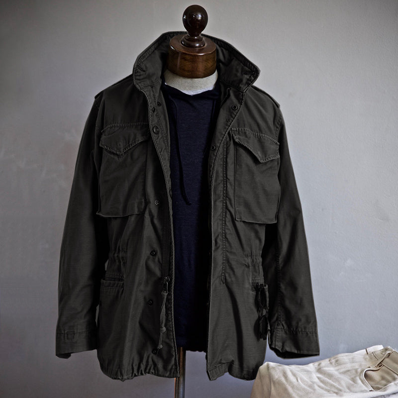 Scott™ Field Jacket by THE WHITMORE FAMILY, olive green outdoor jacket with multiple pockets and durable fabric.