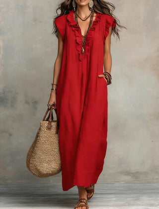 Green Sienna Boho Ruffle Maxi Dress by THE WHITMORE FAMILY, flowing fabric with ruffle details and bohemian style.