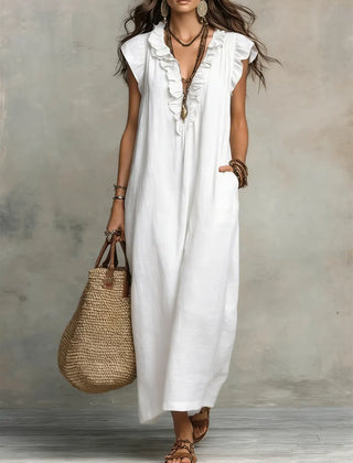 Green Sienna boho ruffle maxi dress by THE WHITMORE FAMILY, flowing fabric with ruffle details and a relaxed fit.