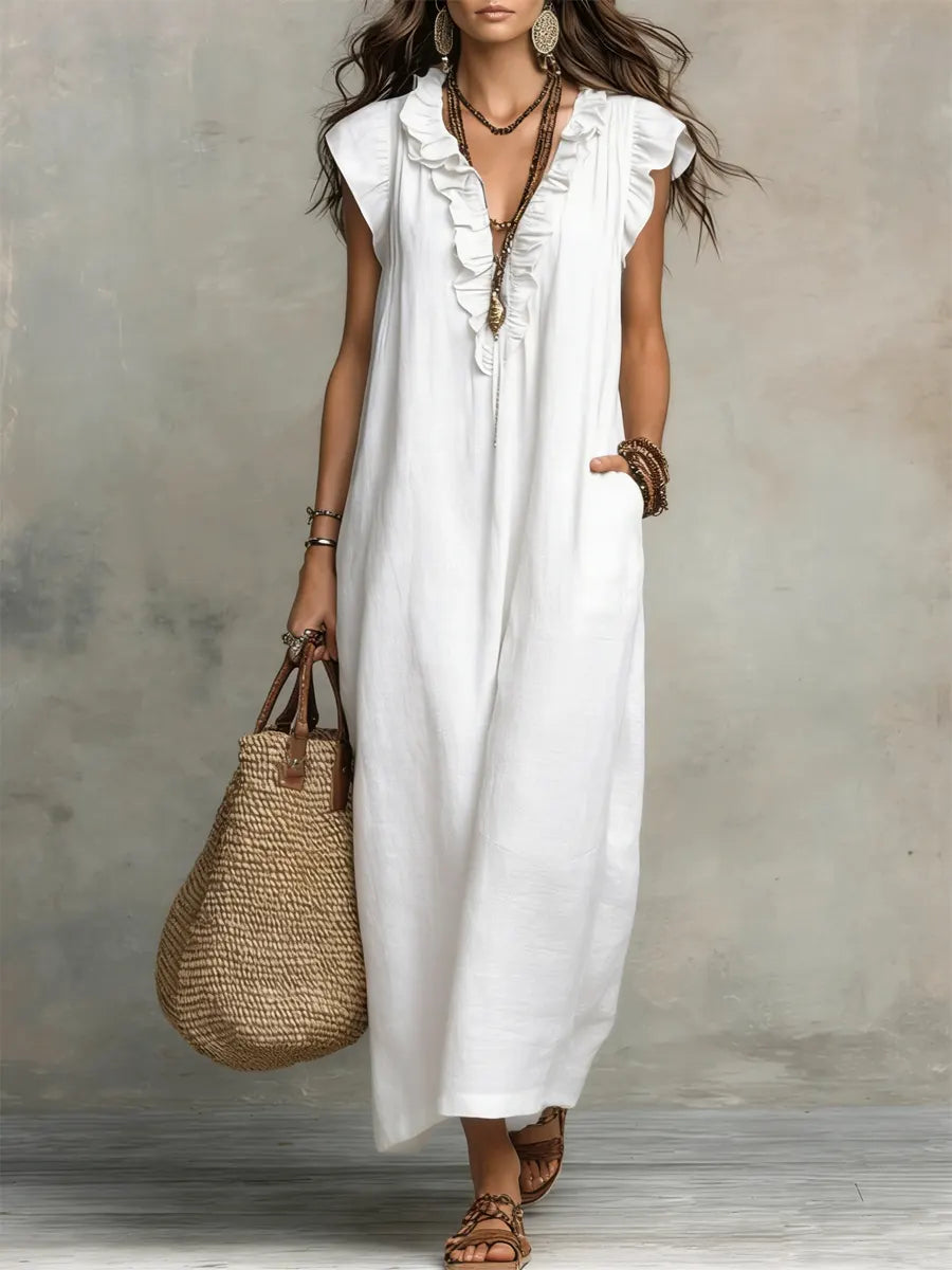 Green Sienna boho ruffle maxi dress by THE WHITMORE FAMILY, flowing fabric with ruffle details and a relaxed fit.