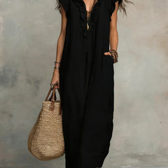 Green Sienna boho ruffle maxi dress by THE WHITMORE FAMILY, flowing fabric with ruffle details and a relaxed, bohemian style.