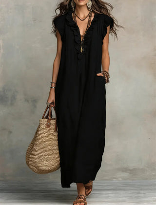 Green Sienna boho ruffle maxi dress by THE WHITMORE FAMILY, flowing fabric with ruffle details and a relaxed, bohemian style.