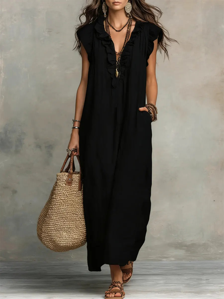 Green Sienna boho ruffle maxi dress by THE WHITMORE FAMILY, flowing fabric with ruffle details and a relaxed, bohemian style.