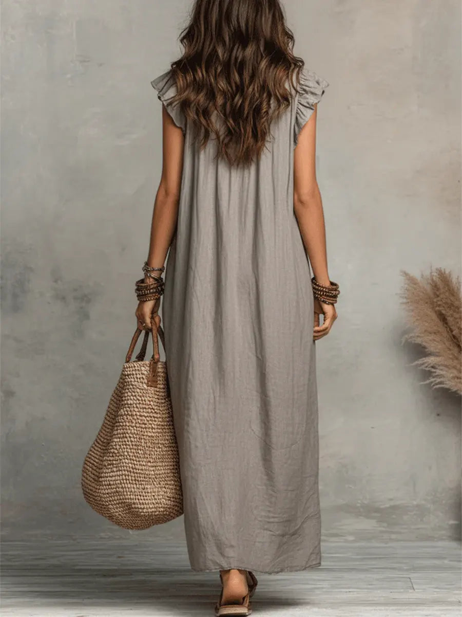 Green Sienna Boho Ruffle Maxi Dress by THE WHITMORE FAMILY, flowing fabric with ruffle details, perfect for casual or summer wear.