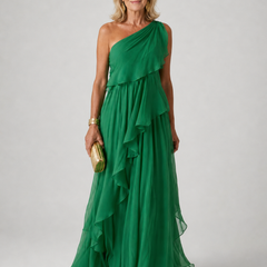 Elegant Victoria maxi dress by The Whitmore Family featuring flowing fabric and a stylish neckline, worn by a model.