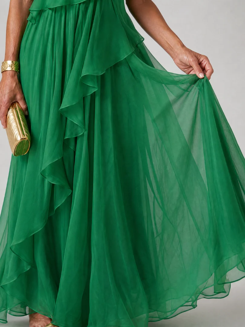 Elegant Victoria maxi dress by The Whitmore Family, featuring flowing fabric and a stylish silhouette.