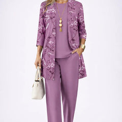 Elegant three-piece trouser set by THE WHITMORE FAMILY featuring a stylish top, matching trousers, and coordinating accessories.