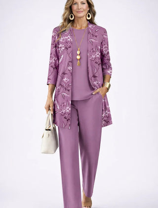 Elegant three-piece trouser set by THE WHITMORE FAMILY featuring a stylish top, matching trousers, and coordinating accessories.