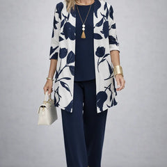 Elegant three-piece trouser set from THE WHITMORE FAMILY featuring tailored pants, a stylish top, and coordinating accessories.