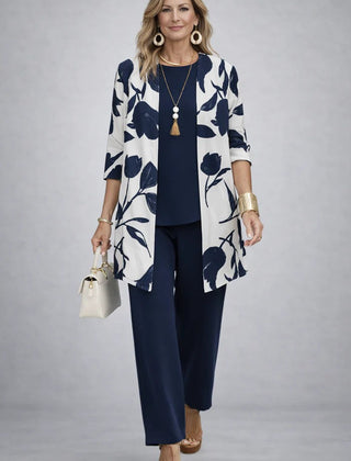 Elegant three-piece trouser set from THE WHITMORE FAMILY featuring tailored pants, a stylish top, and coordinating accessories.