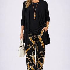 Elegant three-piece trouser set by The Whitmore Family featuring tailored details and sophisticated style.