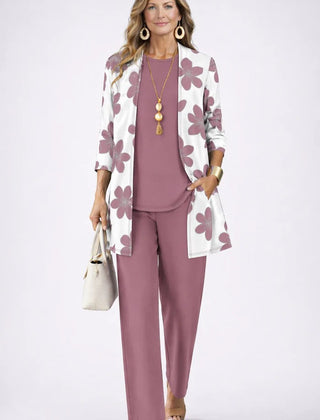 Elegant three-piece trouser set by THE WHITMORE FAMILY featuring a tailored blazer, matching trousers, and a stylish top.
