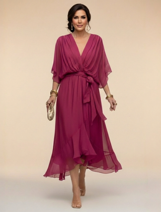 Green Sandra chiffon V-neck dress from THE WHITMORE FAMILY, featuring a flowy silhouette and elegant design.