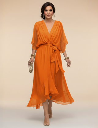 Green Sandra chiffon V-neck dress by THE WHITMORE FAMILY, featuring a flowy silhouette and elegant design.