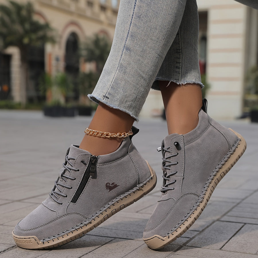 Grey Tara™ ergonomic support sneakers by THE WHITMORE FAMILY with cushioned soles and breathable mesh upper.