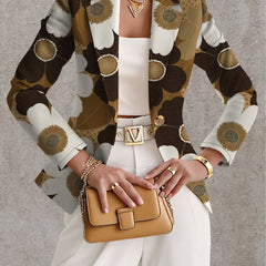 Daisy print blazer by THE WHITMORE FAMILY, featuring tailored fit and vibrant flower pattern, shown on a model.