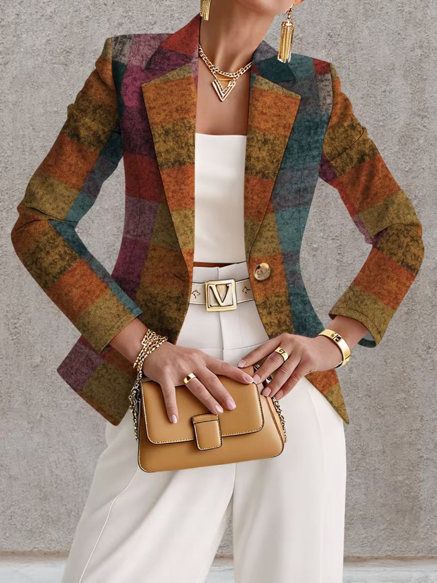 A woman wears the Amandine Autumn Plaid Blazer from THE WHITMORE FAMILY, featuring a stylish plaid pattern and tailored fit.