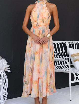 Peach halter maxi dress with floral print from THE WHITMORE FAMILY, featuring a flowing design and sleeveless style.