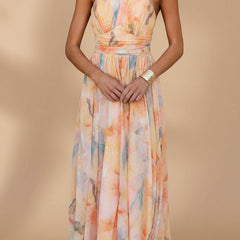 Peach Abigail maxi dress with vibrant print from THE WHITMORE FAMILY, flowing fabric and elegant design for stylish occasions.