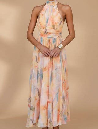Peach Abigail maxi dress with vibrant print from THE WHITMORE FAMILY, flowing fabric and elegant design for stylish occasions.