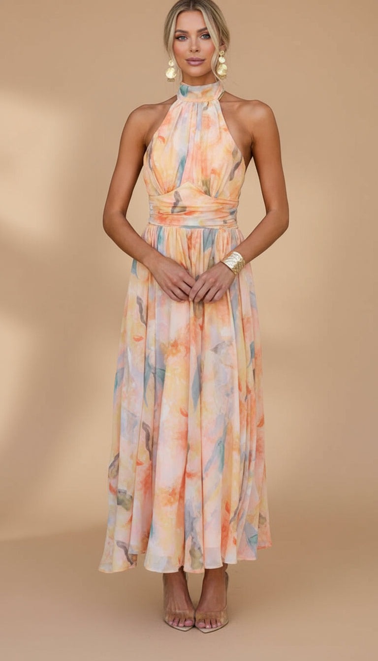 Peach Abigail maxi dress with vibrant print from THE WHITMORE FAMILY, flowing fabric and elegant design for stylish occasions.
