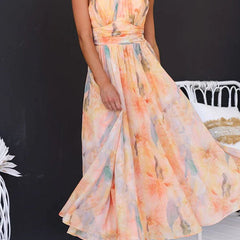 Peach Abigail maxi dress with floral print by THE WHITMORE FAMILY, flowing design, sleeveless style, perfect for summer wear.