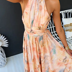 Peach Abigail maxi dress with floral print from THE WHITMORE FAMILY, flowing fabric and elegant design for summer wear.