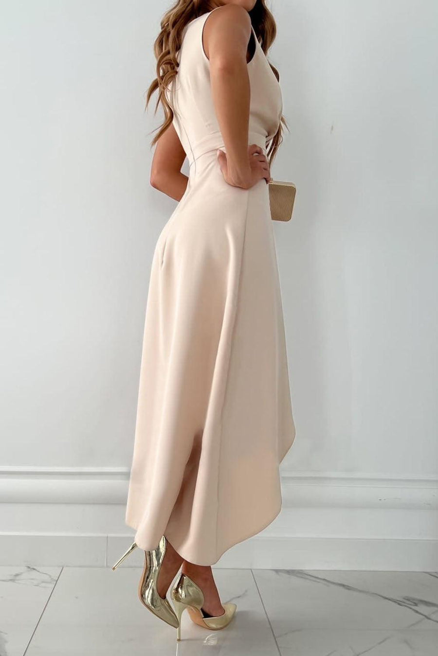 Beige Mandy midi wrap dress with V-neck by THE WHITMORE FAMILY, perfect for wedding guests, shown on a model.