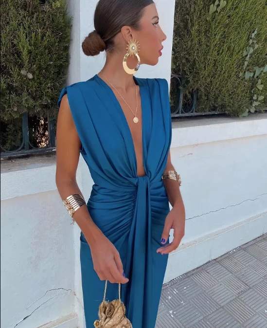 Blue rose-colored elegant pleated dress by THE WHITMORE FAMILY, perfect for wedding guests, stylish and sophisticated.