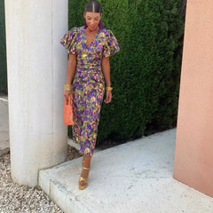 Purple Loren vibrant midi dress with puff sleeves, stylish and elegant for wedding guest attire, by THE WHITMORE FAMILY.